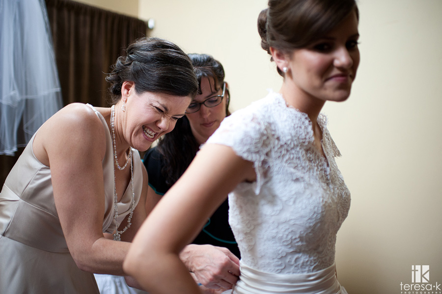 Sacramento area wedding and portrait photographer best of 2011 mother of bride having hard time buttoning the dress